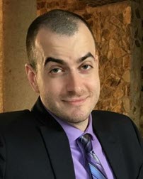 Headshot of Aaron Shbeeb in a suit