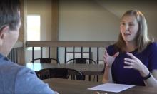 two people sitting at a table talking